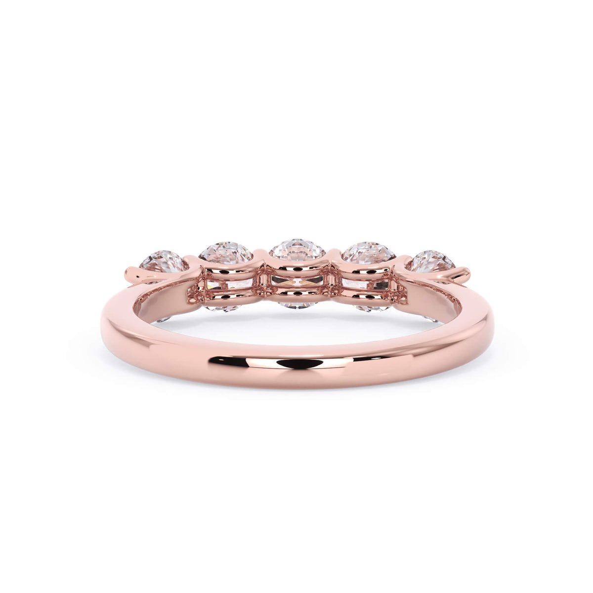 A picture of a five stone diamond wedding ring with round diamonds that are u prong set in rose gold on a white background with a view of the underside of the ring.