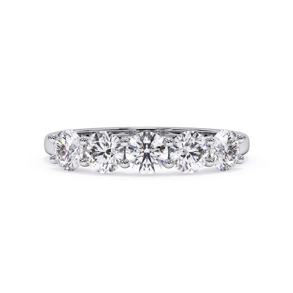 A picture of a five stone diamond wedding ring with round diamonds that are u prong set in white gold or platinum on a white background with the ring facing forward, lying down.