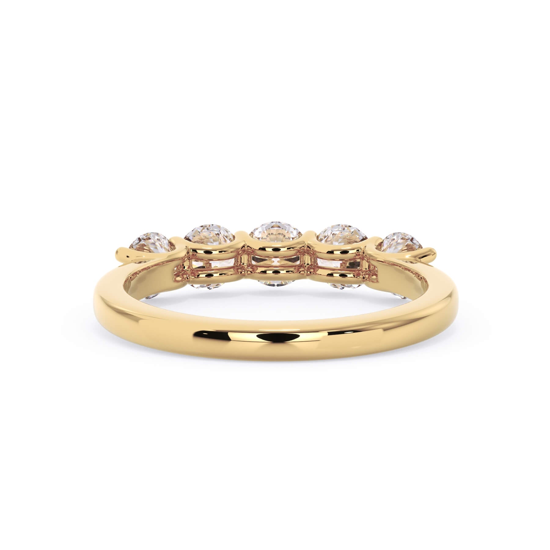 A picture of a five stone diamond wedding ring with round diamonds that are u prong set in yellow gold on a white background with a view of the underside of the ring.