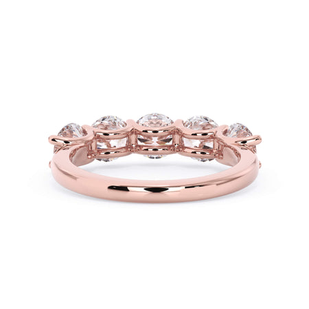 A picture of a five stone diamond wedding ring with round diamonds that are u prong set in rose gold on a white background with a view of the underside of the ring.