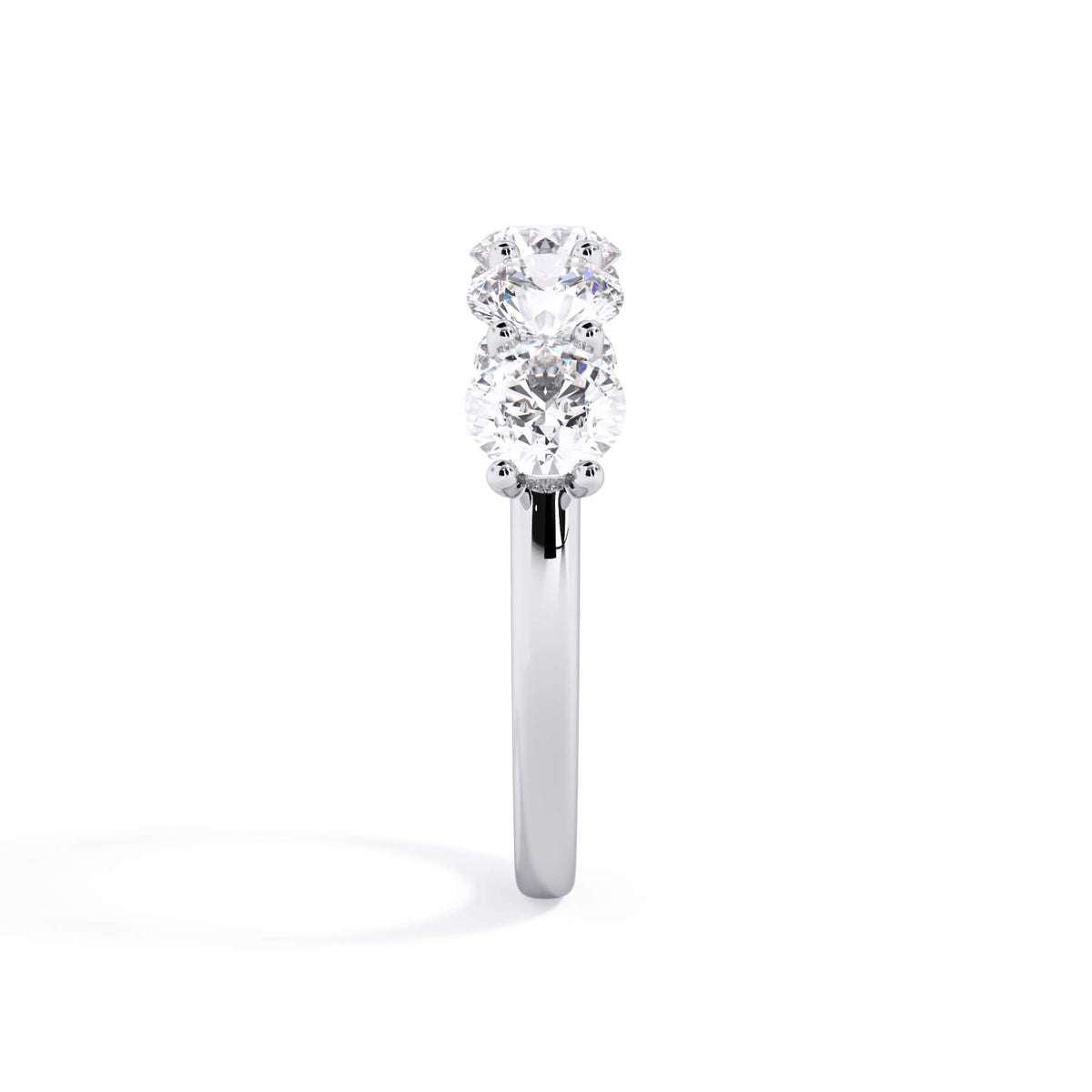 A picture of a five stone diamond wedding ring with round diamonds that are u prong set in white gold or platinum on a white background with a side profile view.