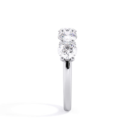 A picture of a five stone diamond wedding ring with round diamonds that are u prong set in white gold or platinum on a white background with a side profile view.