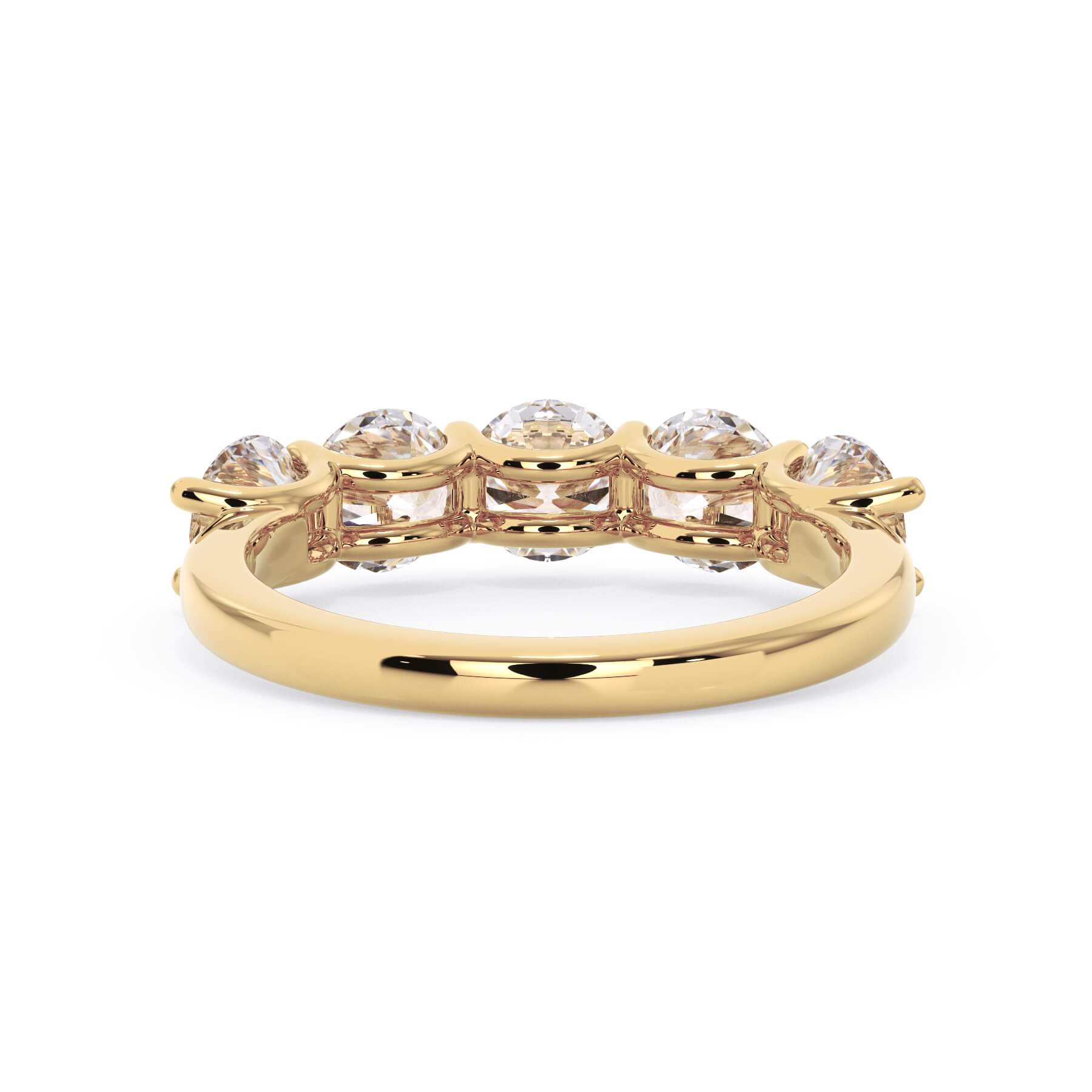 A picture of a five stone diamond wedding ring with round diamonds that are u prong set in yellow gold on a white background with a view of the underside of the ring.