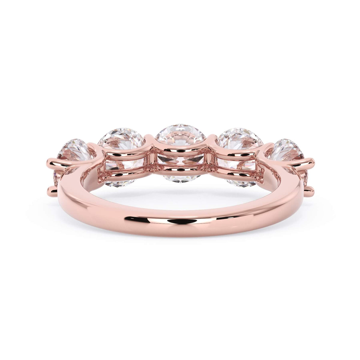 A picture of a five stone diamond wedding ring with round diamonds that are u prong set in rose gold on a white background with a view of the underside of the ring.