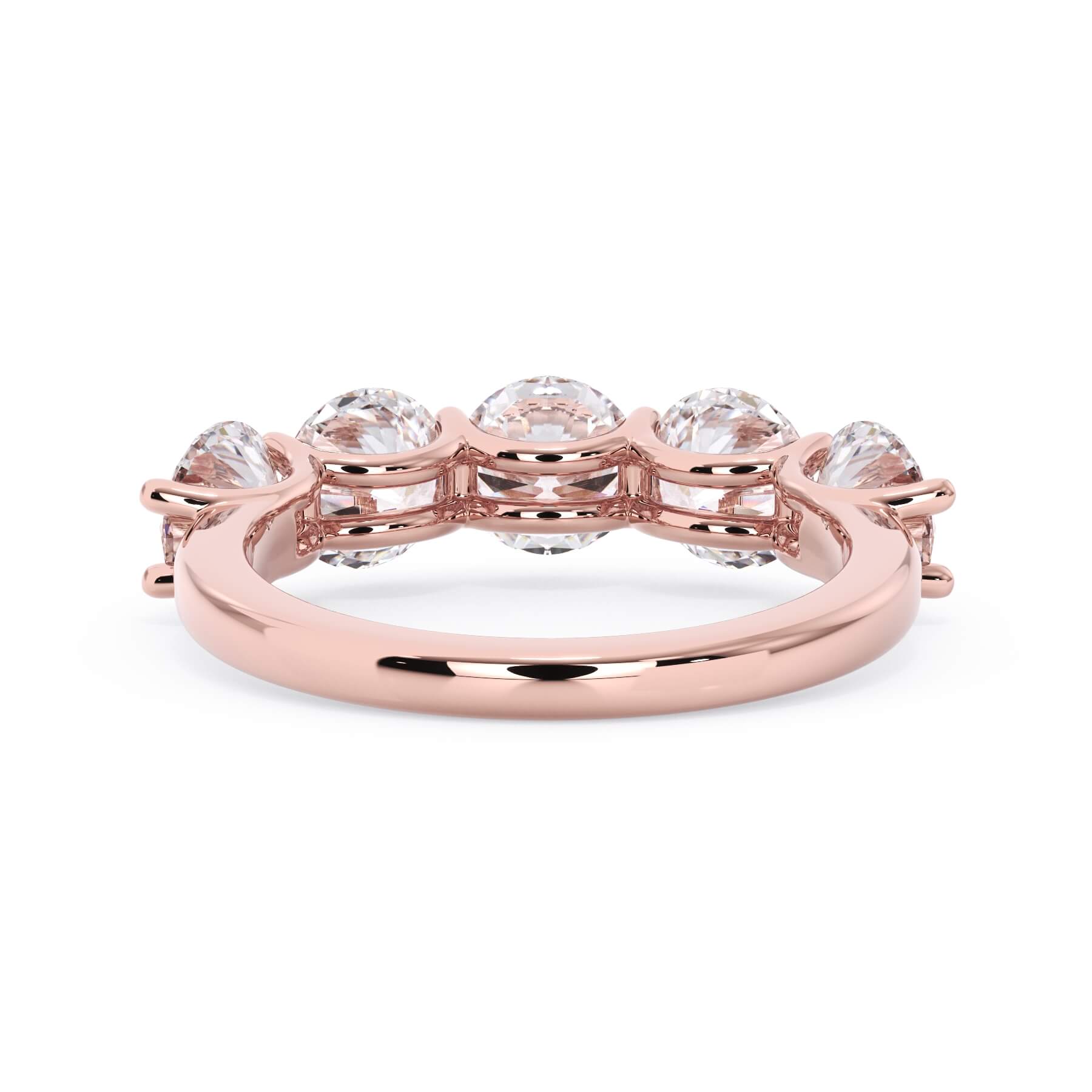 A picture of a five stone diamond wedding ring with round diamonds that are u prong set in rose gold on a white background with a view of the underside of the ring.