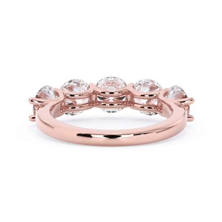 A picture of a five stone diamond wedding ring with round diamonds that are u prong set in rose gold on a white background with a view of the underside of the ring.