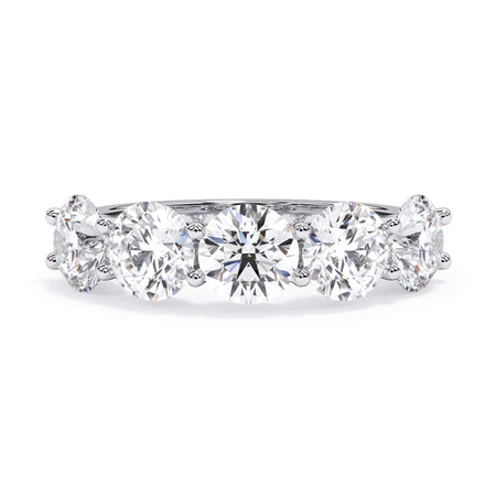 A picture of a five stone diamond wedding ring with round diamonds that are u prong set in white gold or platinum on a white background with the ring facing forward, lying down.