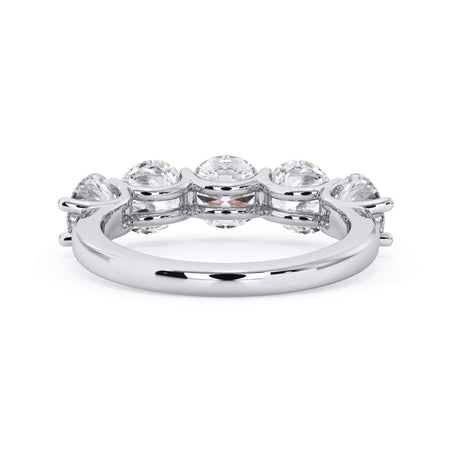 A picture of a five stone diamond wedding ring with round diamonds that are u prong set in white gold or platinum on a white background with a view of the underside of the ring.