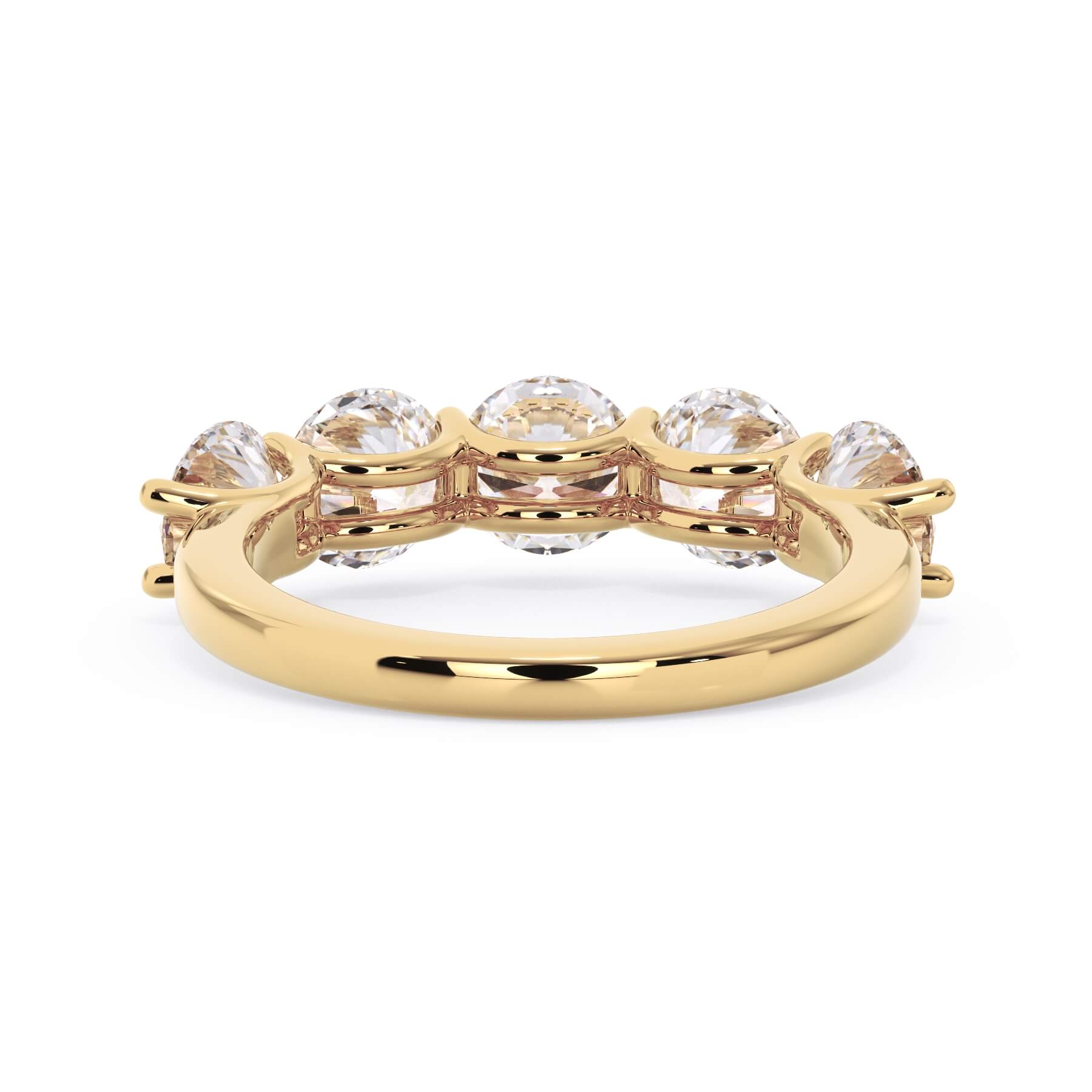 A picture of a five stone diamond wedding ring with round diamonds that are u prong set in yellow gold on a white background with a view of the underside of the ring.
