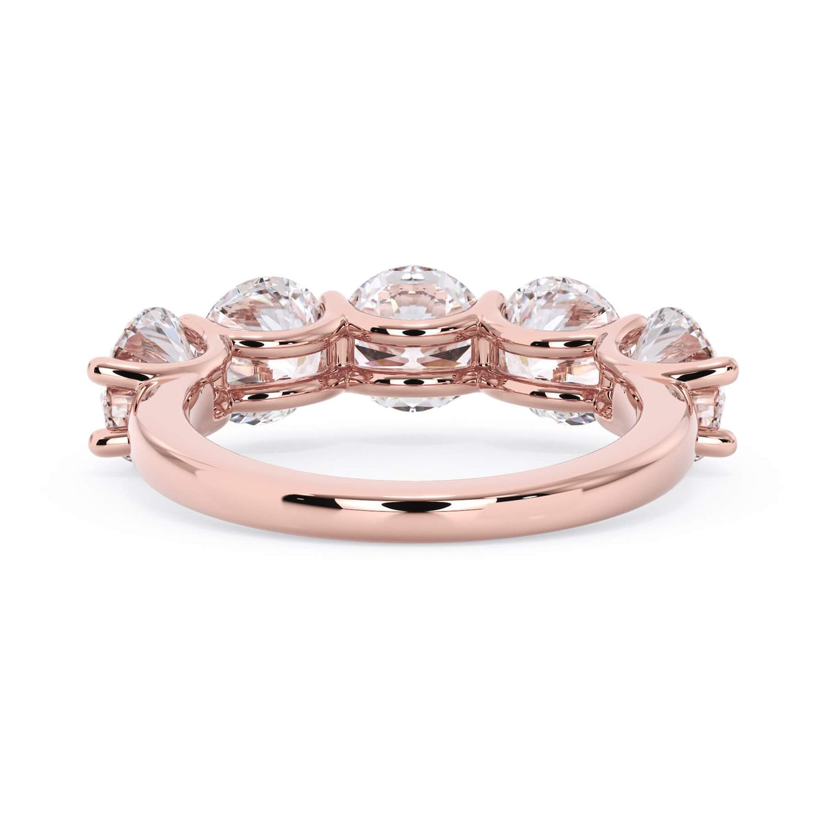 A picture of a five stone diamond wedding ring with round diamonds that are u prong set in rose gold on a white background with a view of the underside of the ring.