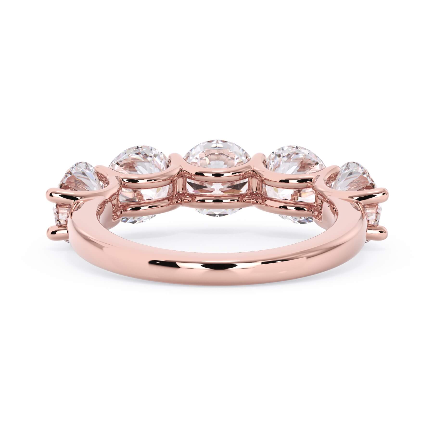 A picture of a five stone diamond wedding ring with round diamonds that are u prong set in rose gold on a white background with a view of the underside of the ring.