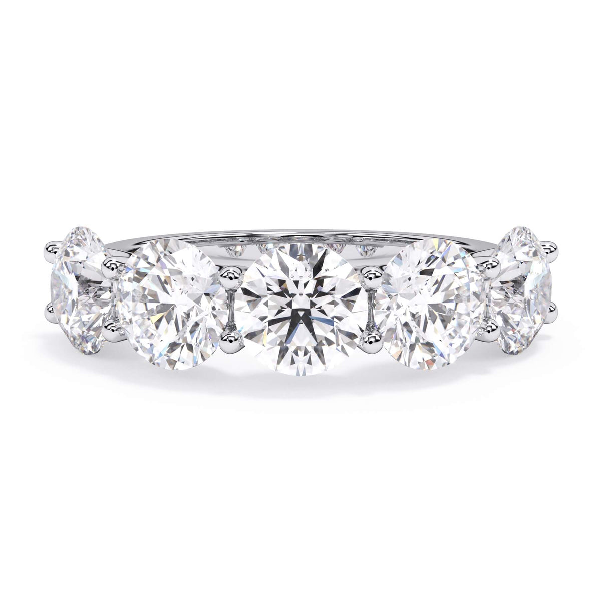 A picture of a five stone diamond wedding ring with round diamonds that are u prong set in white gold or platinum on a white background with the ring facing forward, lying down.