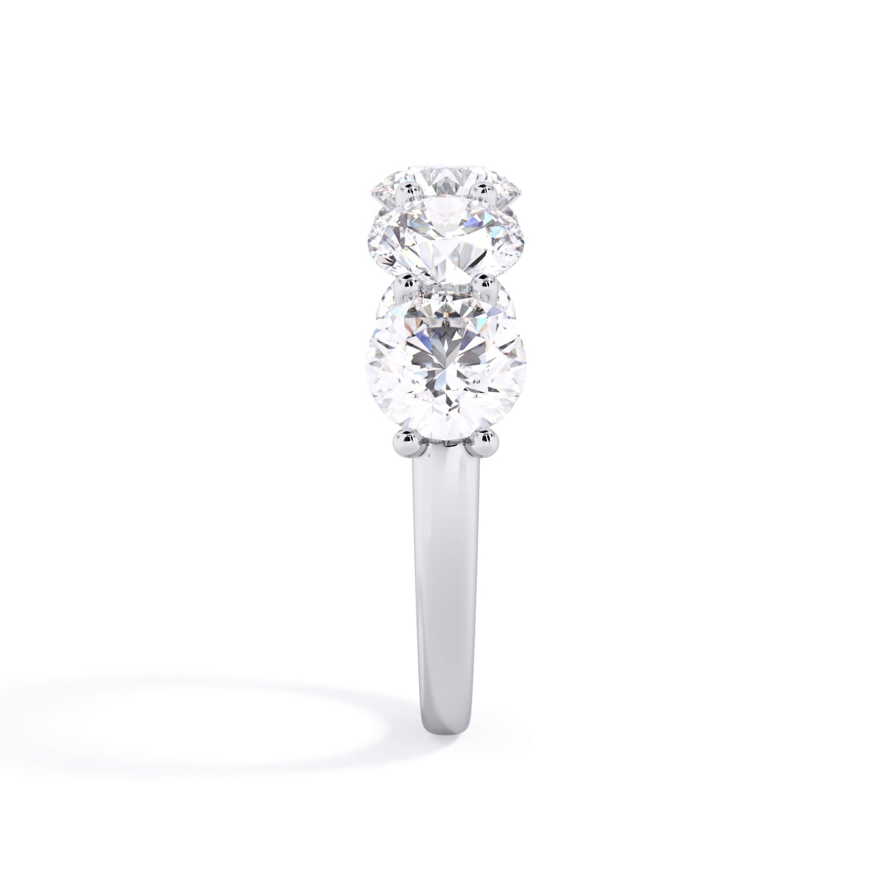 A picture of a five stone diamond wedding ring with round diamonds that are u prong set in white gold or platinum on a white background with a side profile view.