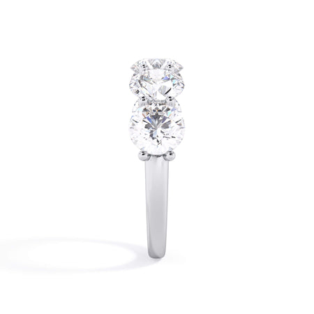 A picture of a five stone diamond wedding ring with round diamonds that are u prong set in white gold or platinum on a white background with a side profile view.