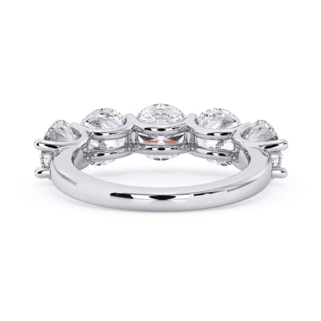 A picture of a five stone diamond wedding ring with round diamonds that are u prong set in white gold or platinum on a white background with a view of the underside of the ring.