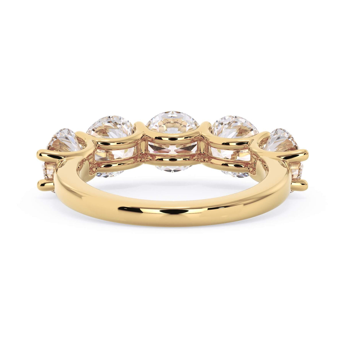 A picture of a five stone diamond wedding ring with round diamonds that are u prong set in yellow gold on a white background with a view of the underside of the ring.