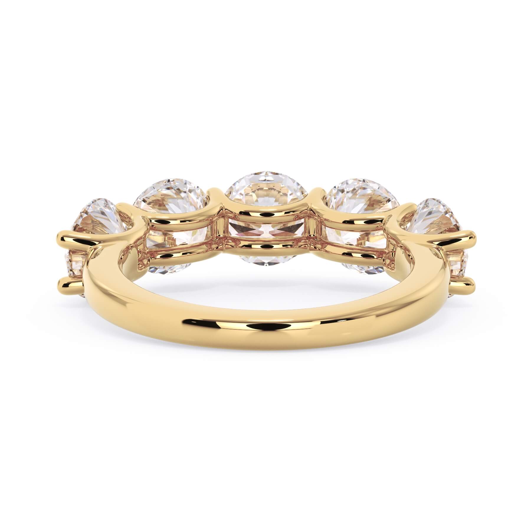 A picture of a five stone diamond wedding ring with round diamonds that are u prong set in yellow gold on a white background with a view of the underside of the ring.