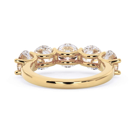 A picture of a five stone diamond wedding ring with round diamonds that are u prong set in yellow gold on a white background with a view of the underside of the ring.