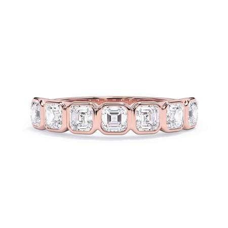 A picture of a seven stone diamond wedding ring with asscher cut diamonds that are bezel set in rose gold on a white background with the ring facing forward, lying down.
