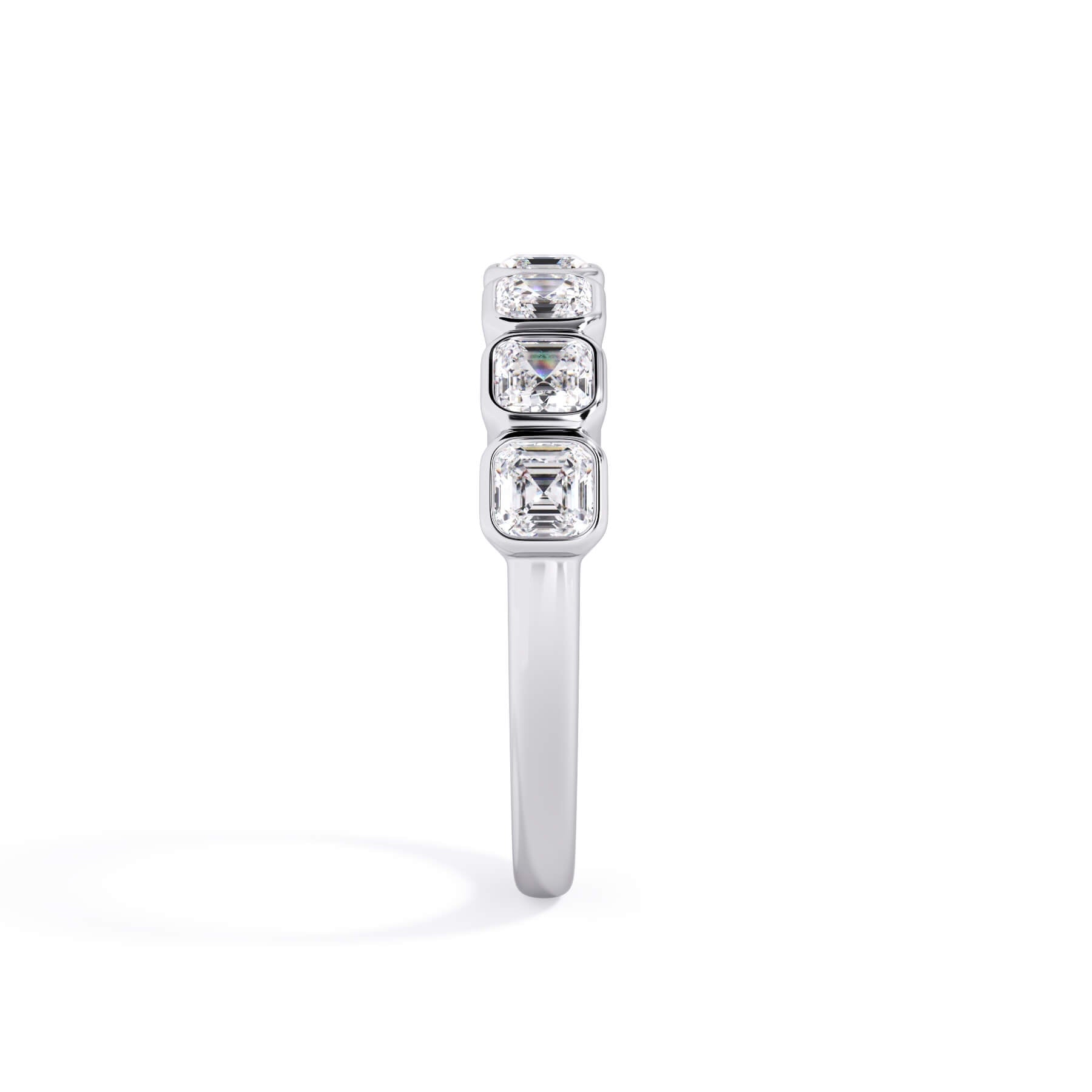 A picture of a seven stone diamond wedding ring with asscher cut diamonds that are bezel set in white gold or platinum on a white background with a side profile view.