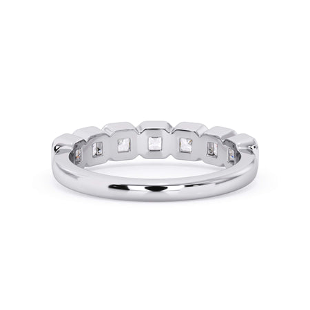 A picture of a seven stone diamond wedding ring with asscher cut diamonds that are bezel set in white gold or platinum on a white background with a view of the underside of the ring.