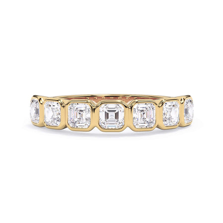A picture of a seven stone diamond wedding ring with asscher cut diamonds that are bezel set in yellow gold on a white background with the ring facing forward, lying down.