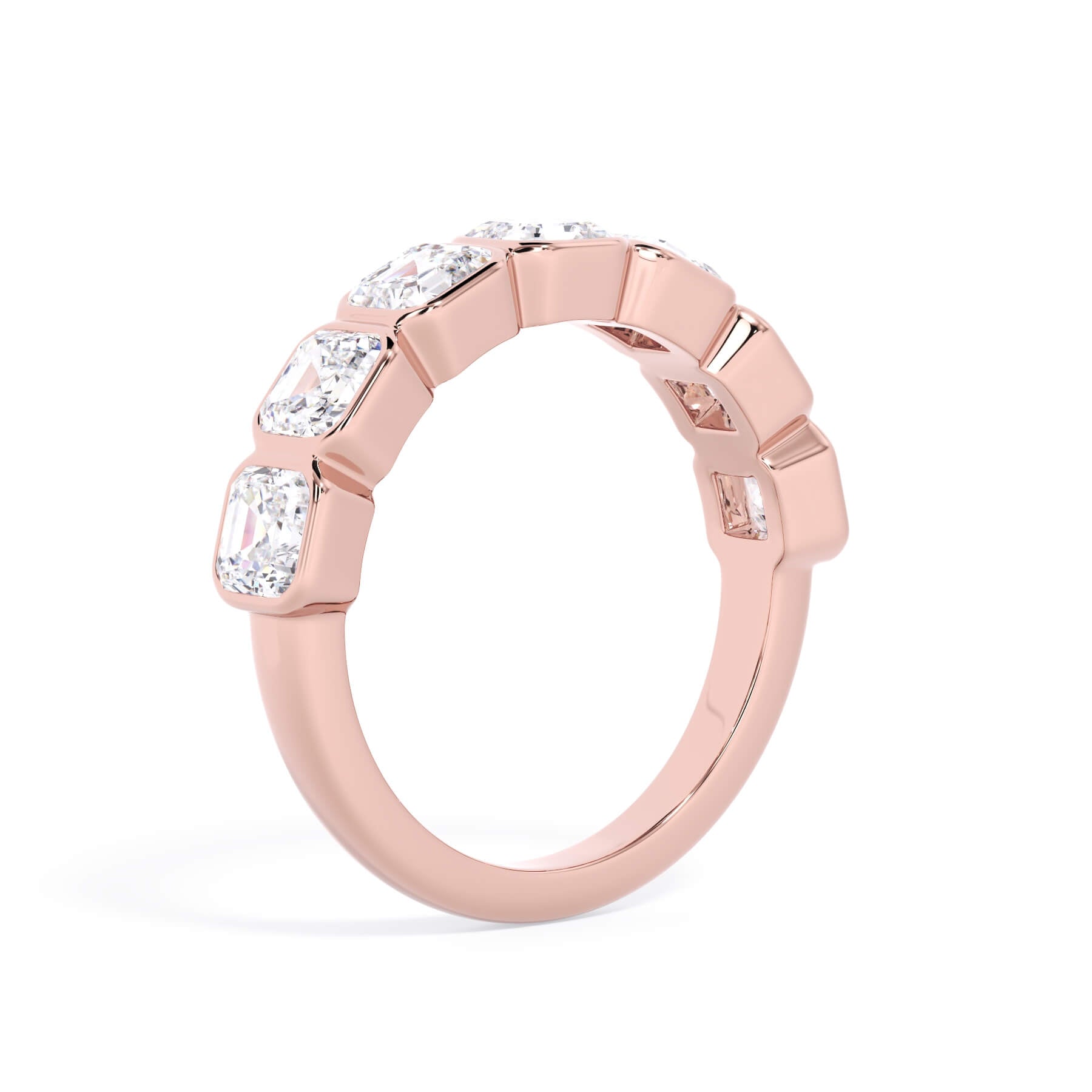 A picture of a seven stone diamond wedding ring with asscher cut diamonds that are bezel set in rose gold on a white background with a slightly angled, through the finger view.