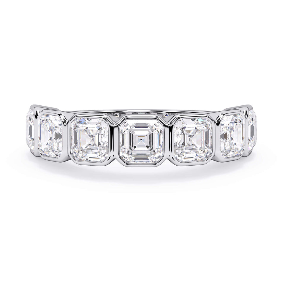 A picture of a seven stone diamond wedding ring with asscher cut diamonds that are bezel set in white gold or platinum on a white background with the ring facing forward, lying down.