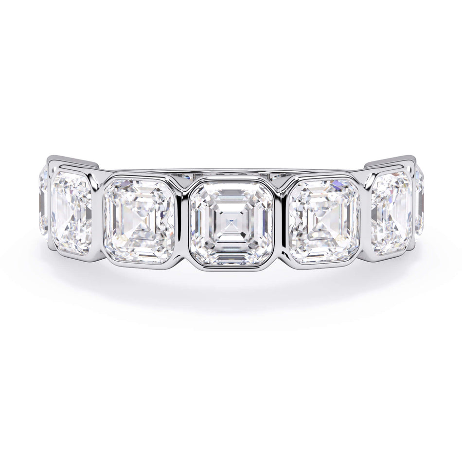 A picture of a seven stone diamond wedding ring with asscher cut diamonds that are bezel set in white gold or platinum on a white background with the ring facing forward, lying down.