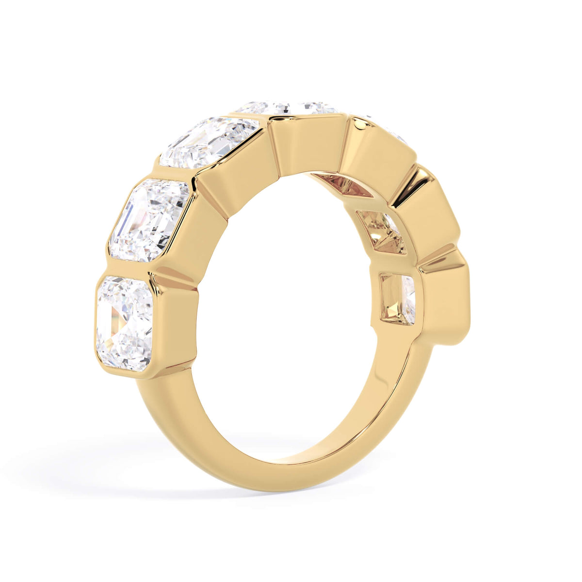 A picture of a seven stone diamond wedding ring with asscher cut diamonds that are bezel set in yellow gold on a white background with a slightly angled, through the finger view.