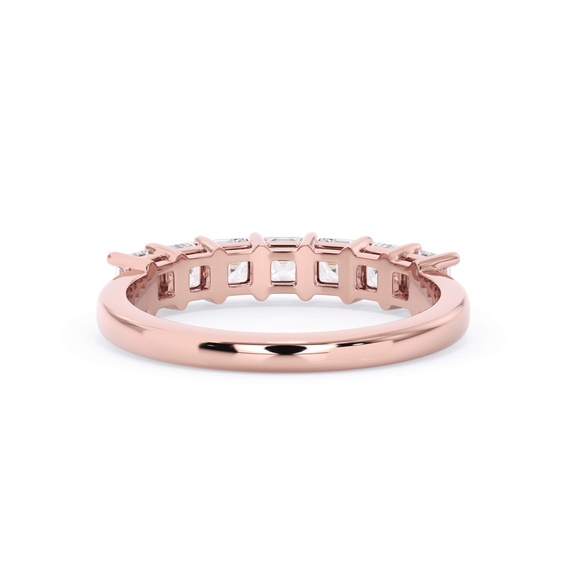 A picture of a seven stone diamond wedding ring with asscher cut diamonds that are shared prong set in rose gold on a white background with a view of the underside of the ring.