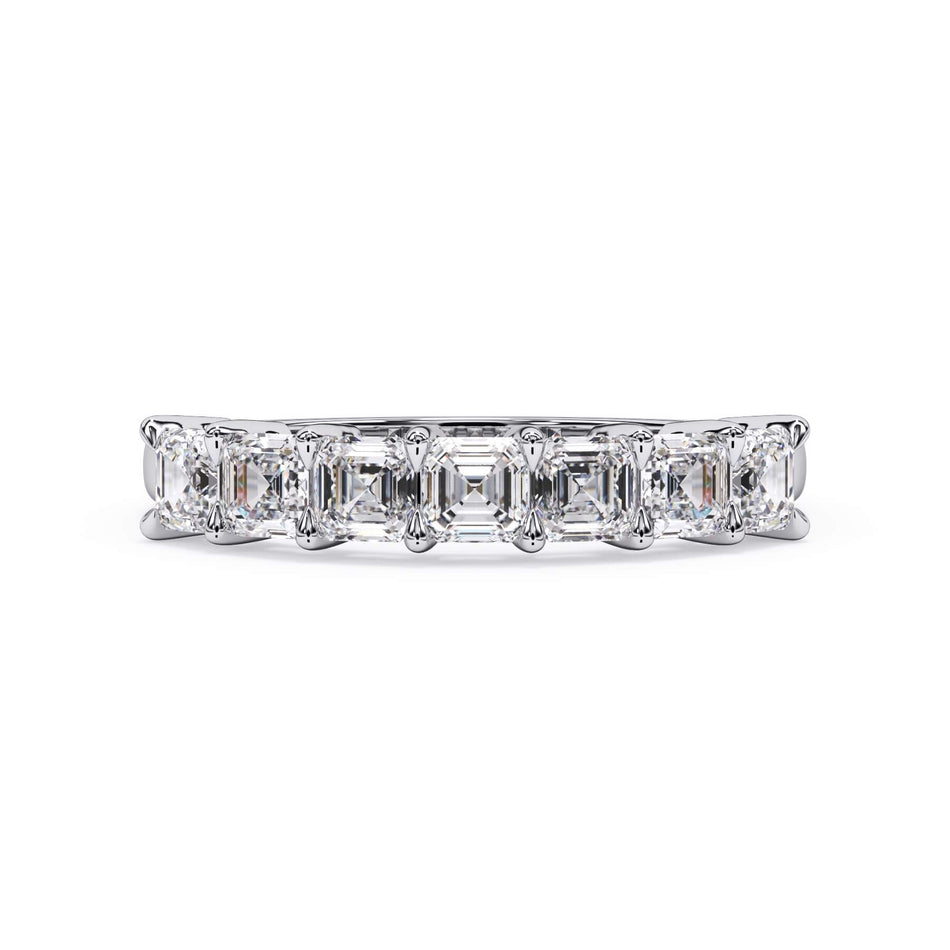 A picture of a seven stone diamond wedding ring with asscher cut diamonds that are shared prong set in white gold or platinum on a white background with the ring facing forward, lying down.
