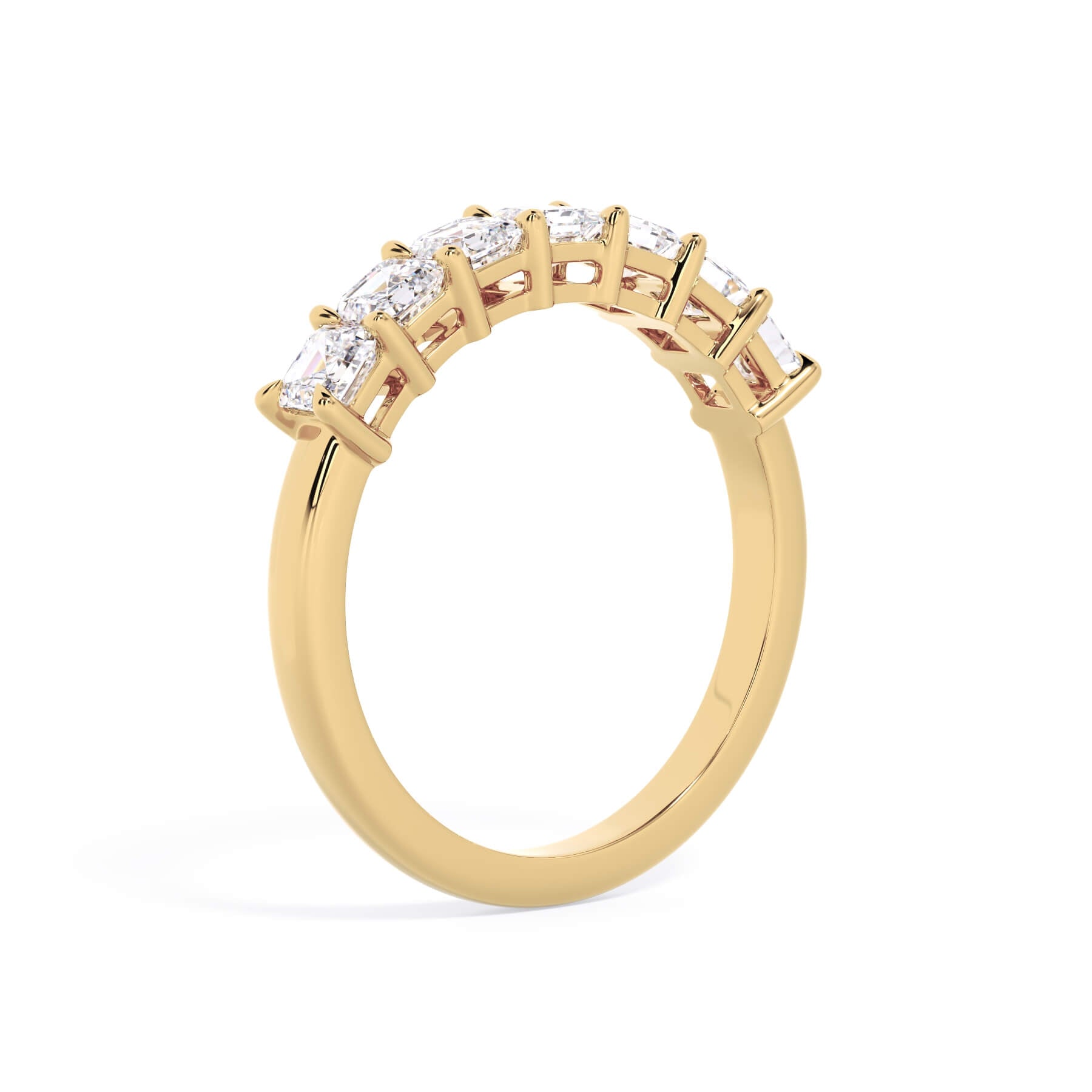 A picture of a seven stone diamond wedding ring with asscher cut diamonds that are shared prong set in yellow gold on a white background with a slightly angled, through the finger view.