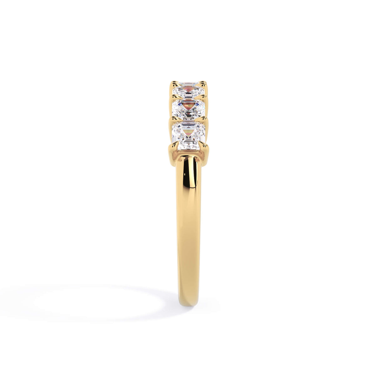 A picture of a seven stone diamond wedding ring with asscher cut diamonds that are shared prong set in yellow gold on a white background with a side profile view.