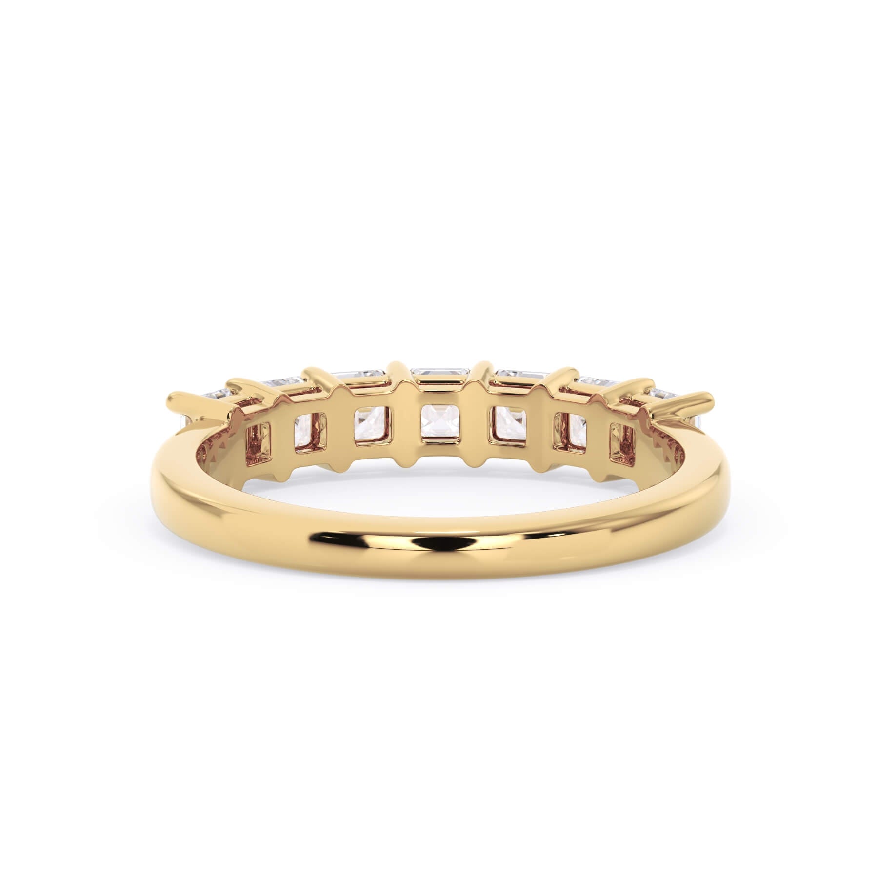 A picture of a seven stone diamond wedding ring with asscher cut diamonds that are shared prong set in yellow gold on a white background with a view of the underside of the ring.