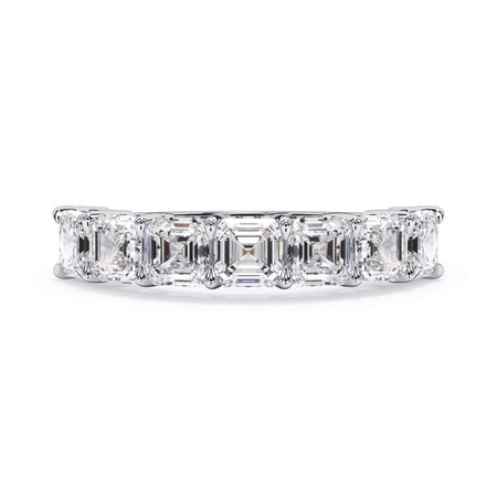 A picture of a seven stone diamond wedding ring with asscher cut diamonds that are shared prong set in white gold or platinum on a white background with the ring facing forward, lying down.