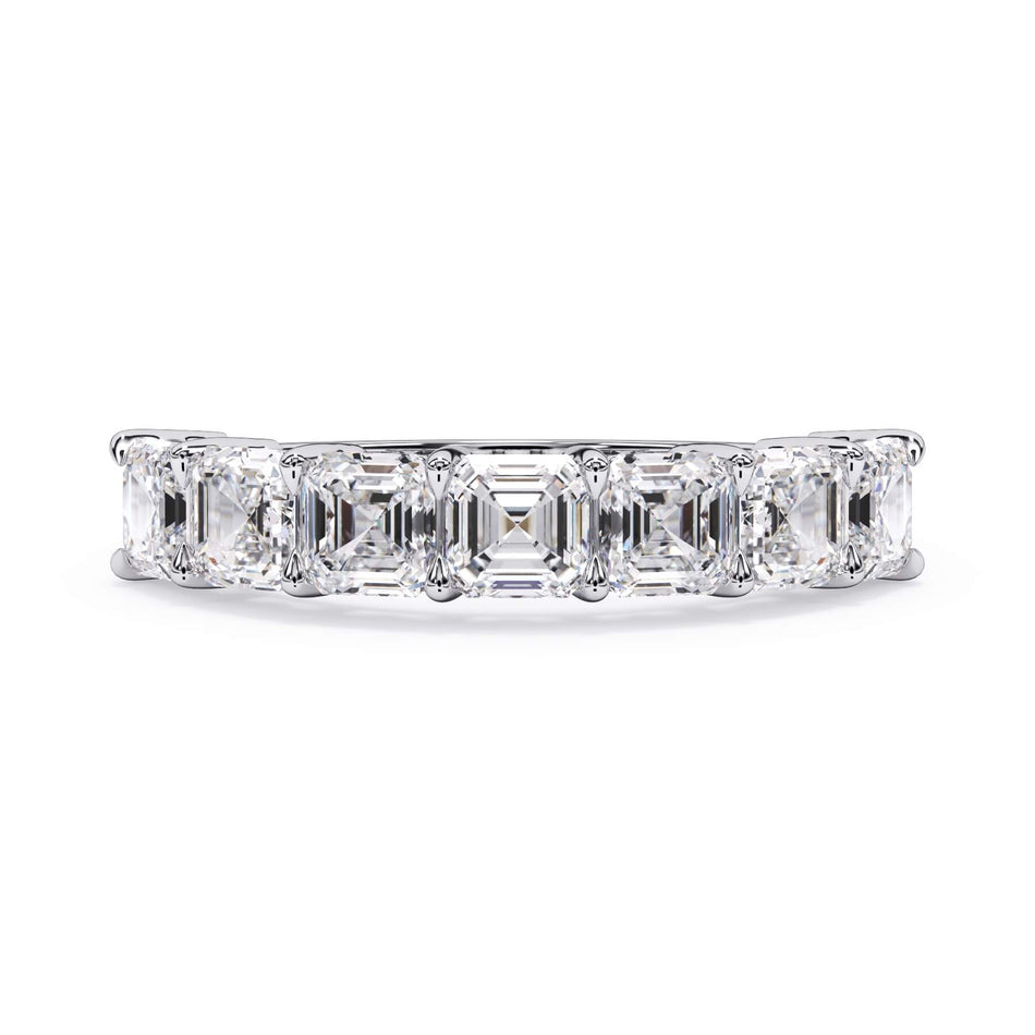A picture of a seven stone diamond wedding ring with asscher cut diamonds that are shared prong set in white gold or platinum on a white background with the ring facing forward, lying down.