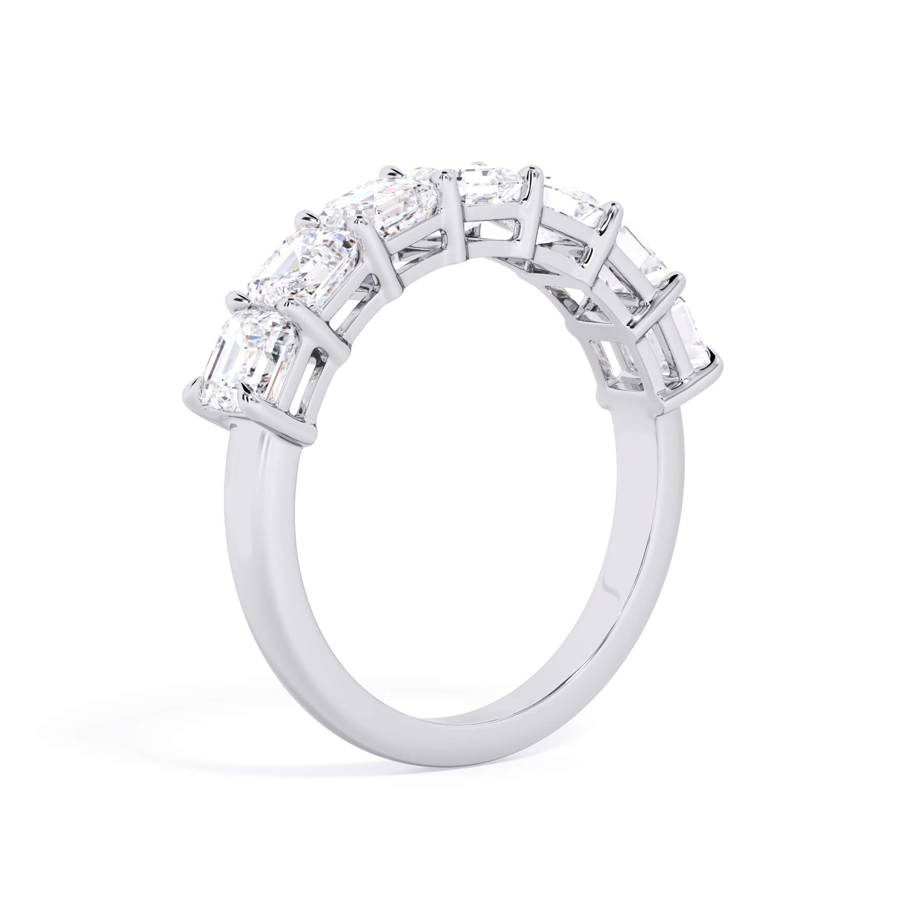 A picture of a seven stone diamond wedding ring with asscher cut diamonds that are shared prong set in white gold or platinum on a white background with a slightly angled, through the finger view.
