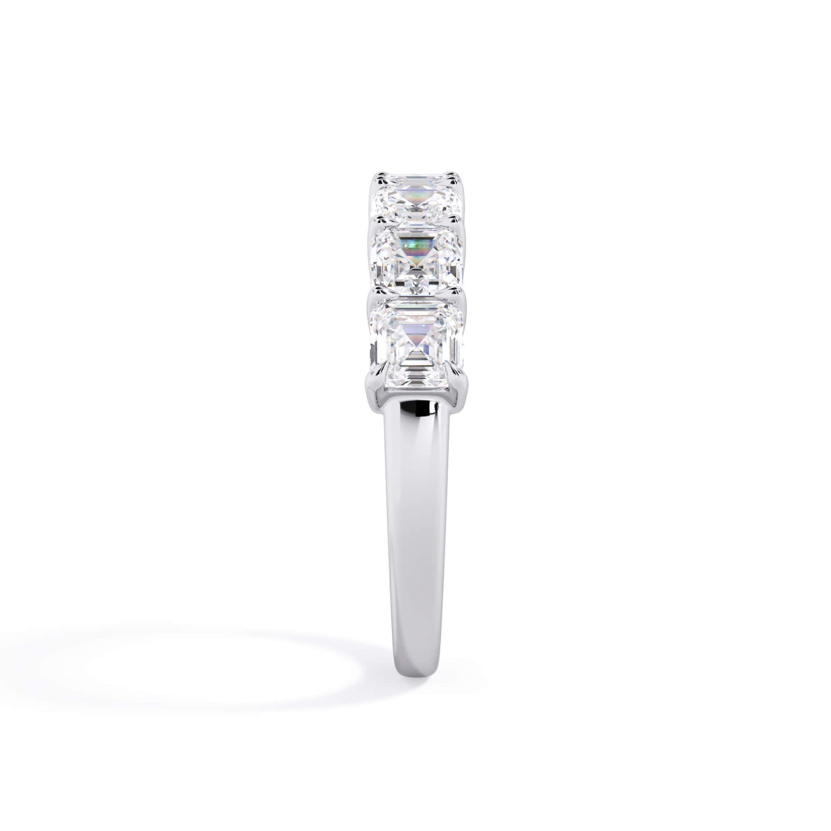 A picture of a seven stone diamond wedding ring with asscher cut diamonds that are shared prong set in white gold or platinum on a white background with a side profile view.
