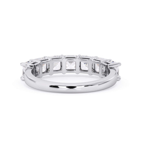 A picture of a seven stone diamond wedding ring with asscher cut diamonds that are shared prong set in white gold or platinum on a white background with a view of the underside of the ring.