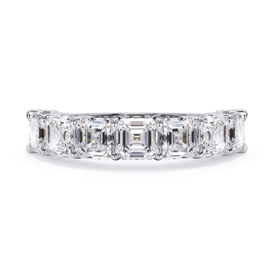 A picture of a seven stone diamond wedding ring with asscher cut diamonds that are shared prong set in white gold or platinum on a white background with the ring facing forward, lying down.