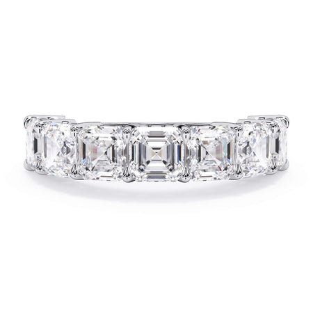 A picture of a seven stone diamond wedding ring with asscher cut diamonds that are shared prong set in white gold or platinum on a white background with the ring facing forward, lying down.