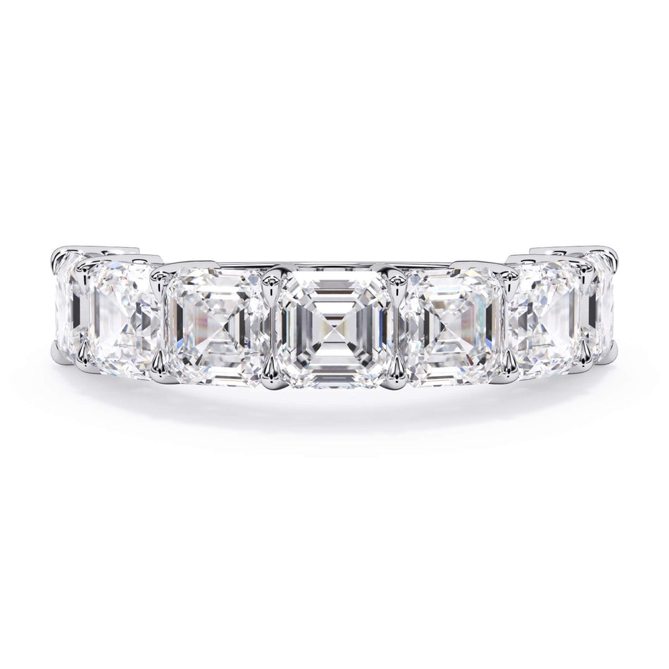 A picture of a seven stone diamond wedding ring with asscher cut diamonds that are shared prong set in white gold or platinum on a white background with the ring facing forward, lying down.
