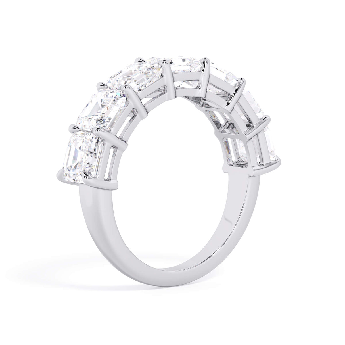A picture of a seven stone diamond wedding ring with asscher cut diamonds that are shared prong set in white gold or platinum on a white background with a slightly angled, through the finger view.