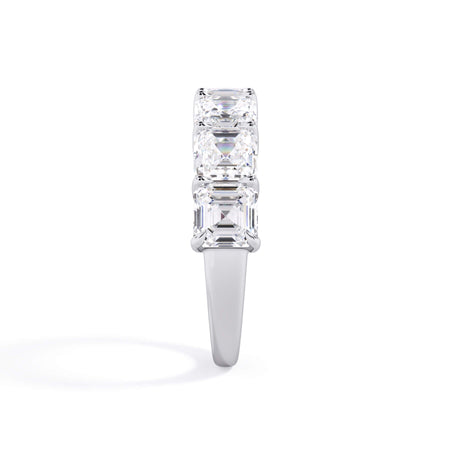 A picture of a seven stone diamond wedding ring with asscher cut diamonds that are shared prong set in white gold or platinum on a white background with a side profile view.