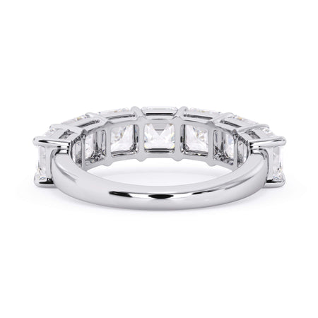 A picture of a seven stone diamond wedding ring with asscher cut diamonds that are shared prong set in white gold or platinum on a white background with a view of the underside of the ring.