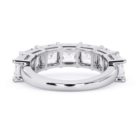 A picture of a seven stone diamond wedding ring with asscher cut diamonds that are shared prong set in white gold or platinum on a white background with a view of the underside of the ring.