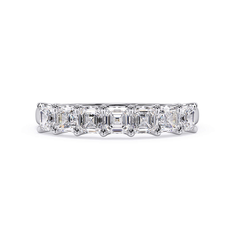 A picture of a seven stone diamond wedding ring with asscher cut diamonds that are U prong set in white gold or platinum on a white background with the ring facing forward, lying down.