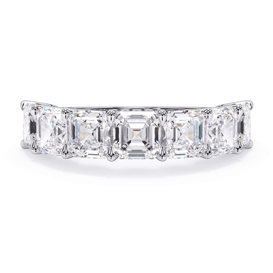 A picture of a seven stone diamond wedding ring with asscher cut diamonds that are U prong set in white gold or platinum on a white background with the ring facing forward, lying down.