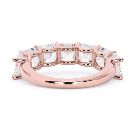 A picture of a seven stone diamond wedding ring with asscher cut diamonds that are U prong set in rose gold on a white background with a view of the underside of the ring.